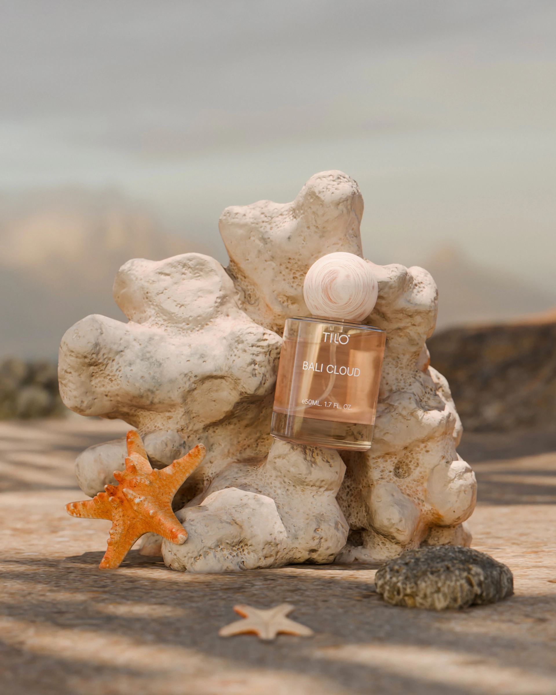 A bottle of perfume sitting on top of a pile of rocks