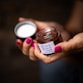 A woman holding a jar with a label on it
