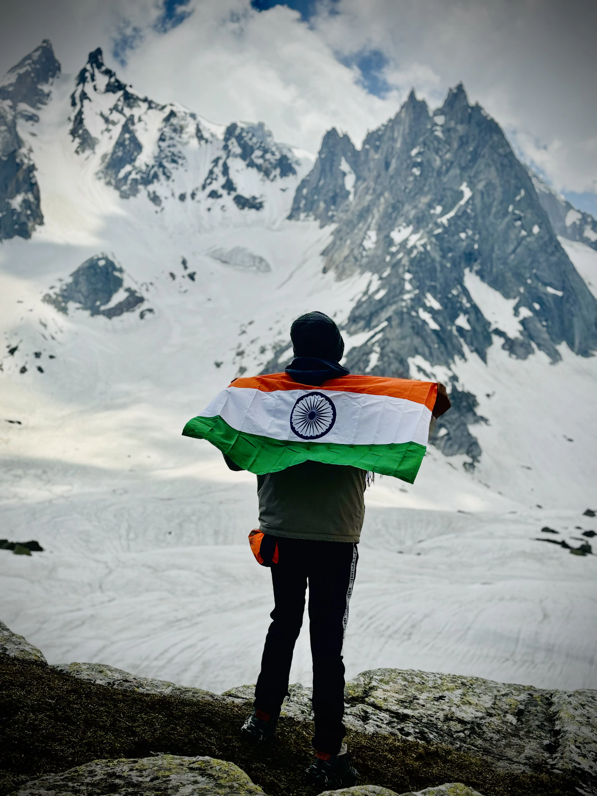 A man standing on top of a snow covered mountain