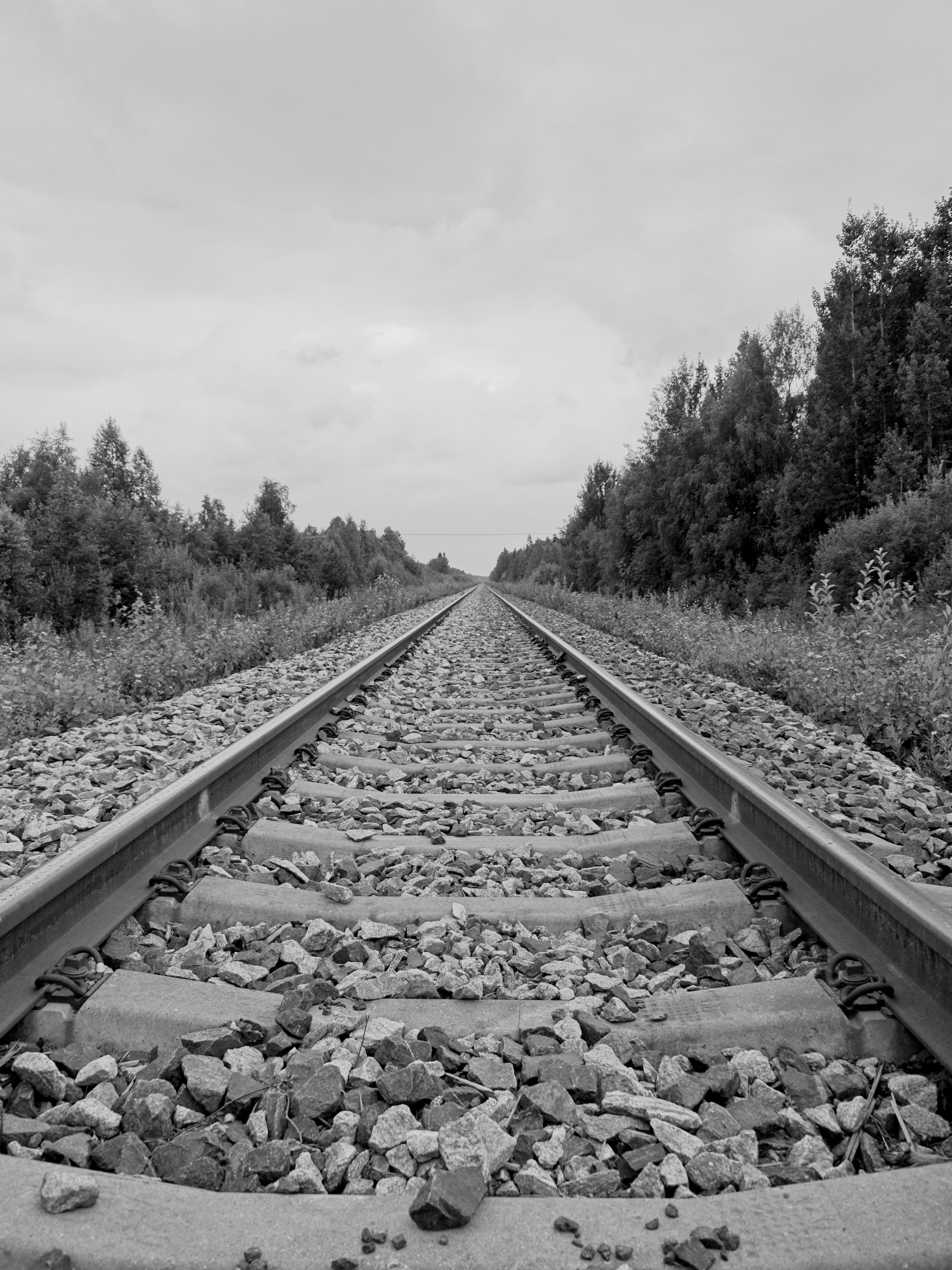 A black and white photo of a train track