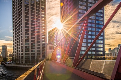 The sun is shining brightly over a bridge