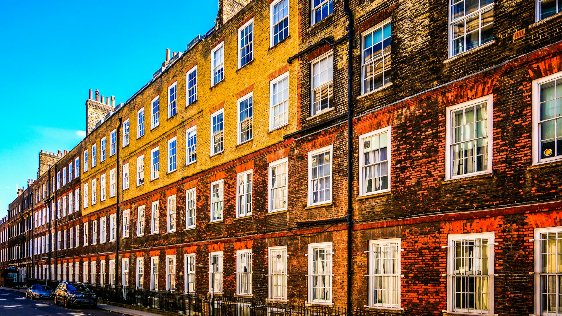 A row of brick buildings with white windows