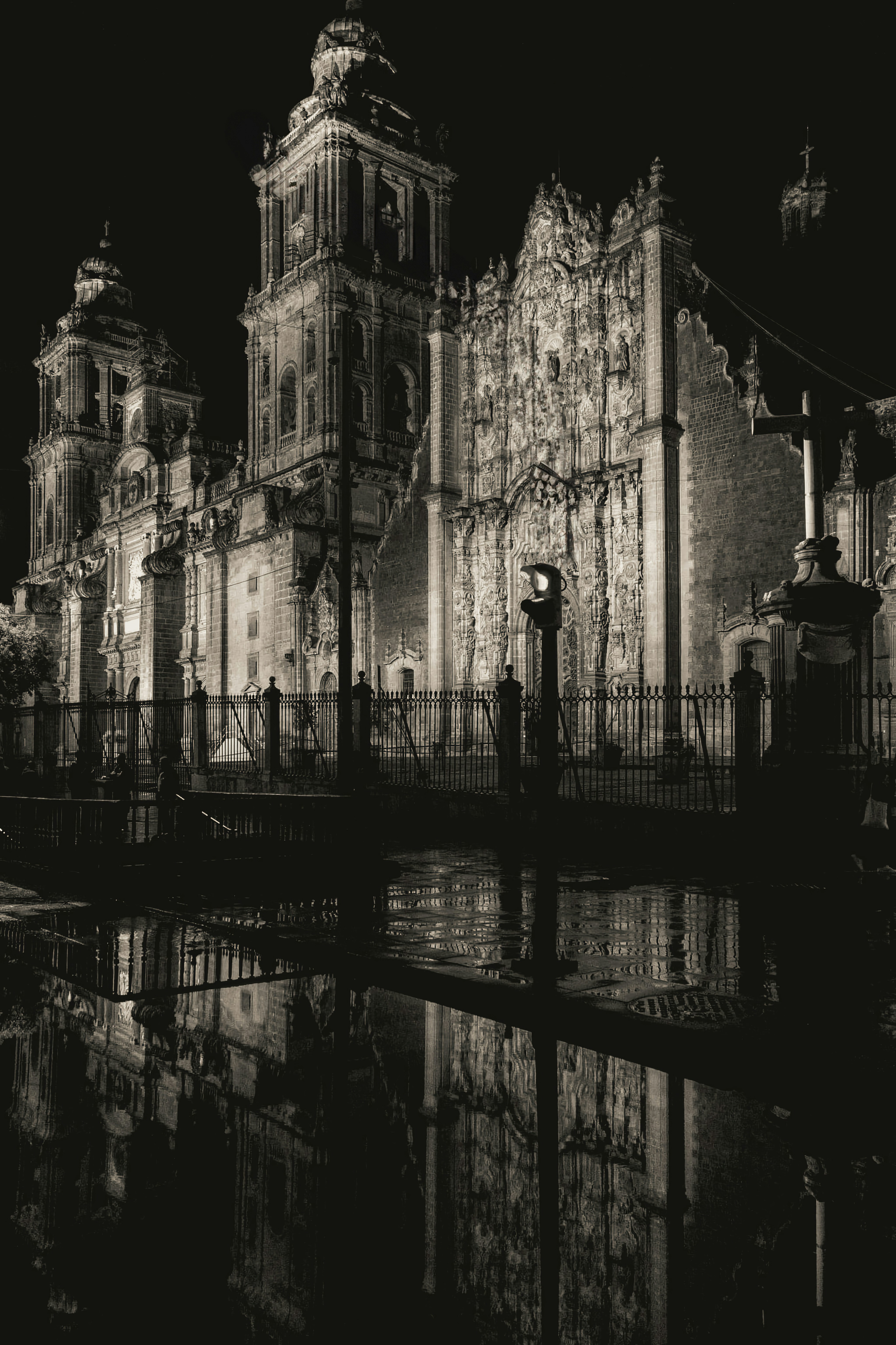 A black and white photo of a building at night