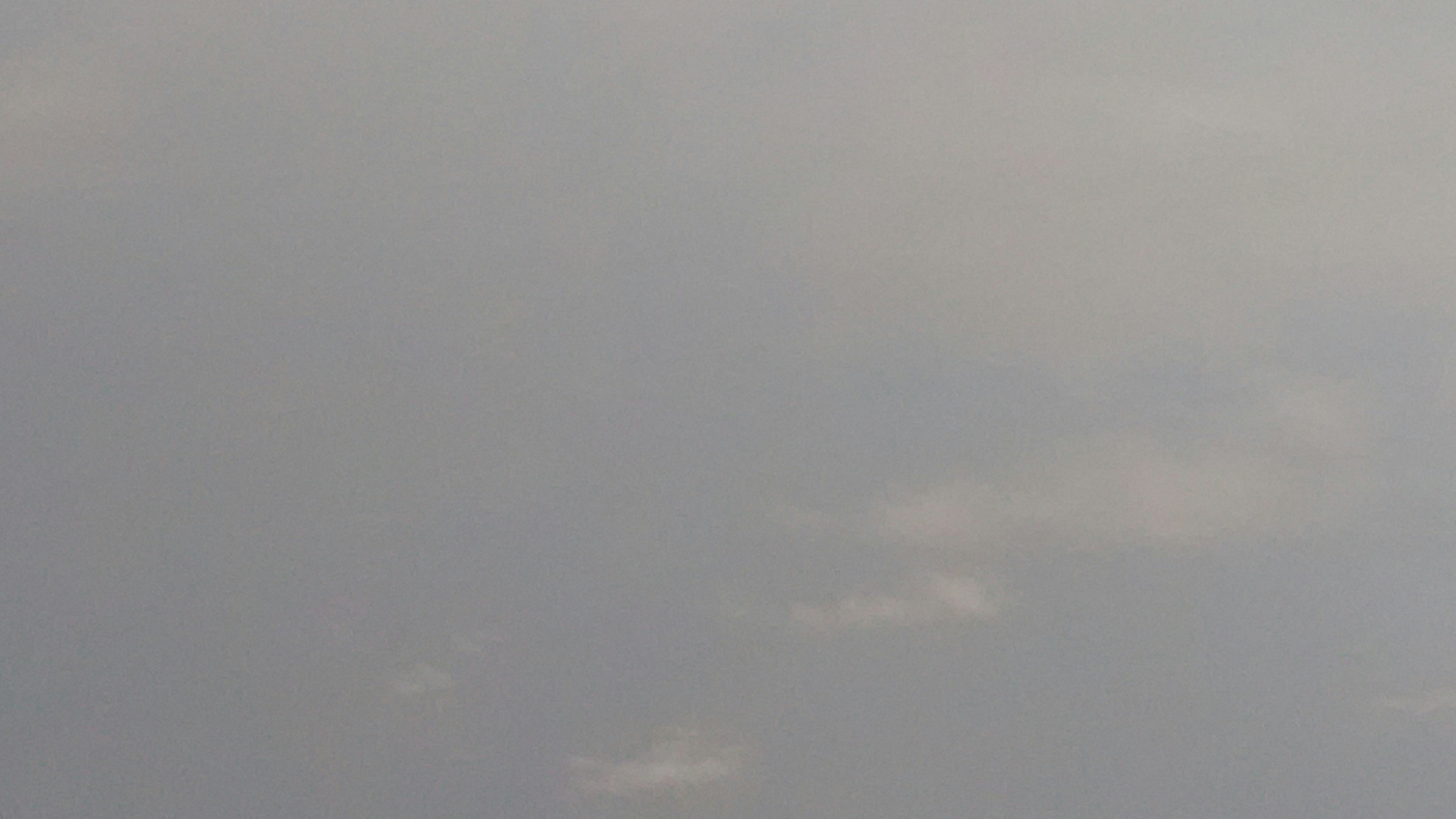 A person flying a kite on a cloudy day