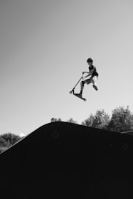 A man flying through the air while riding a skateboard