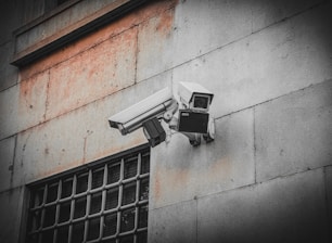 A security camera attached to the side of a building