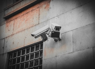 A security camera attached to the side of a building
