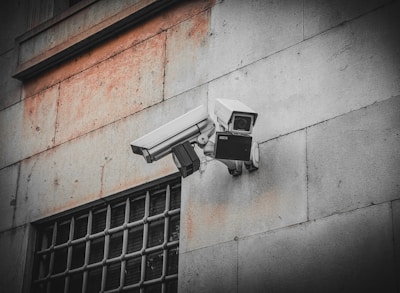 A security camera attached to the side of a building