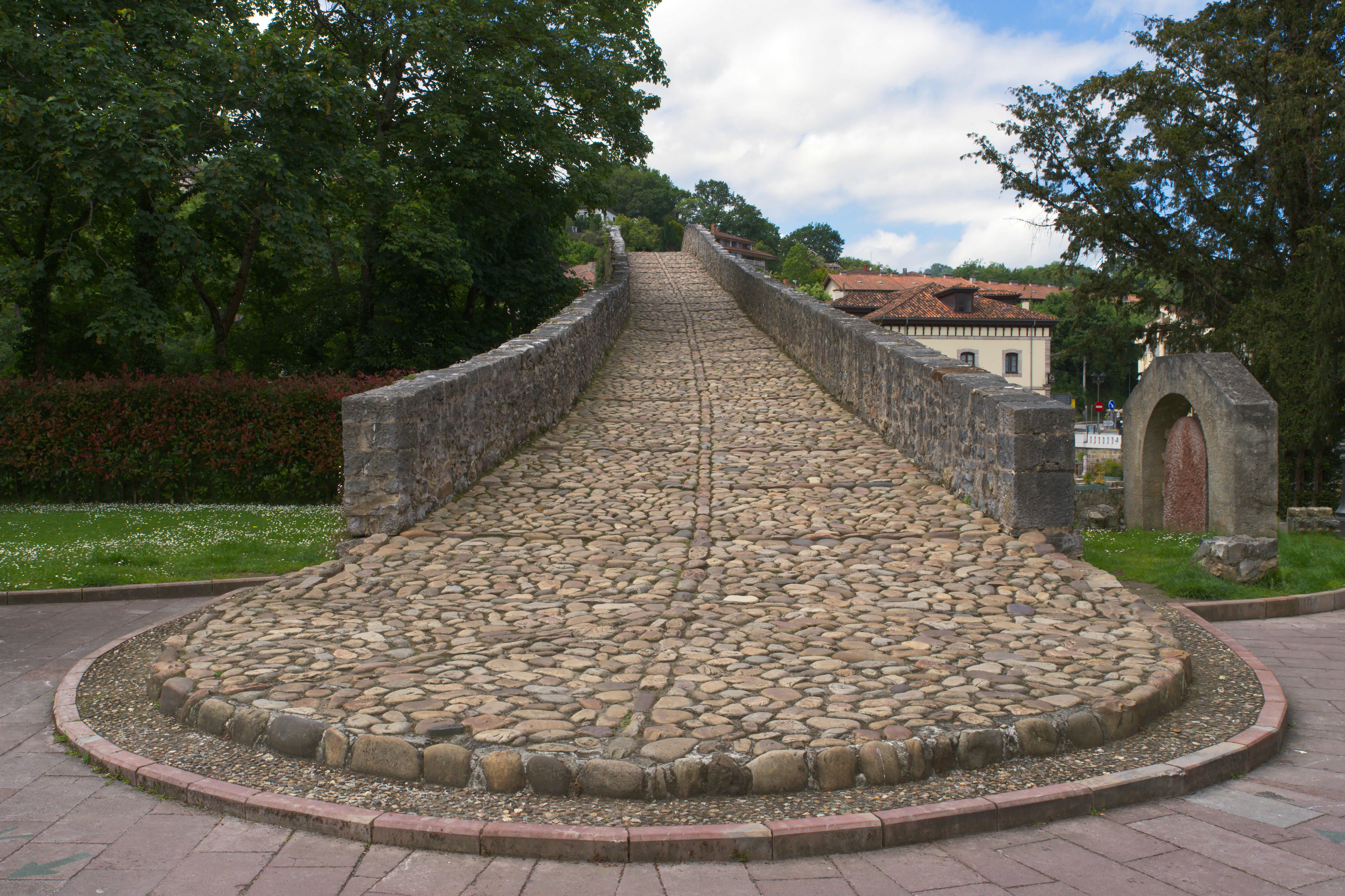 A stone bridge with a circular walkway in the middle of it