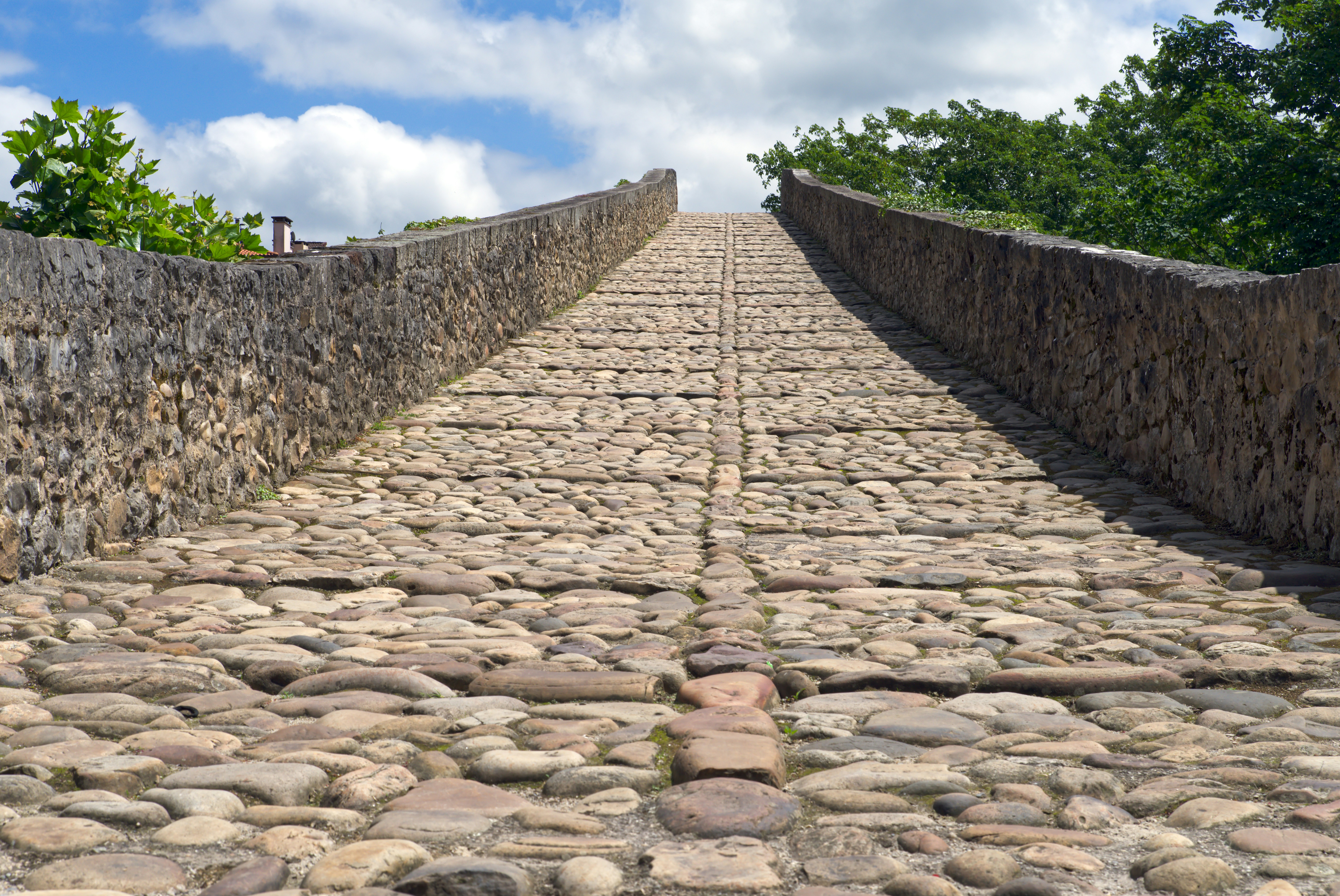 A stone bridge with a walkway made of cobblestones