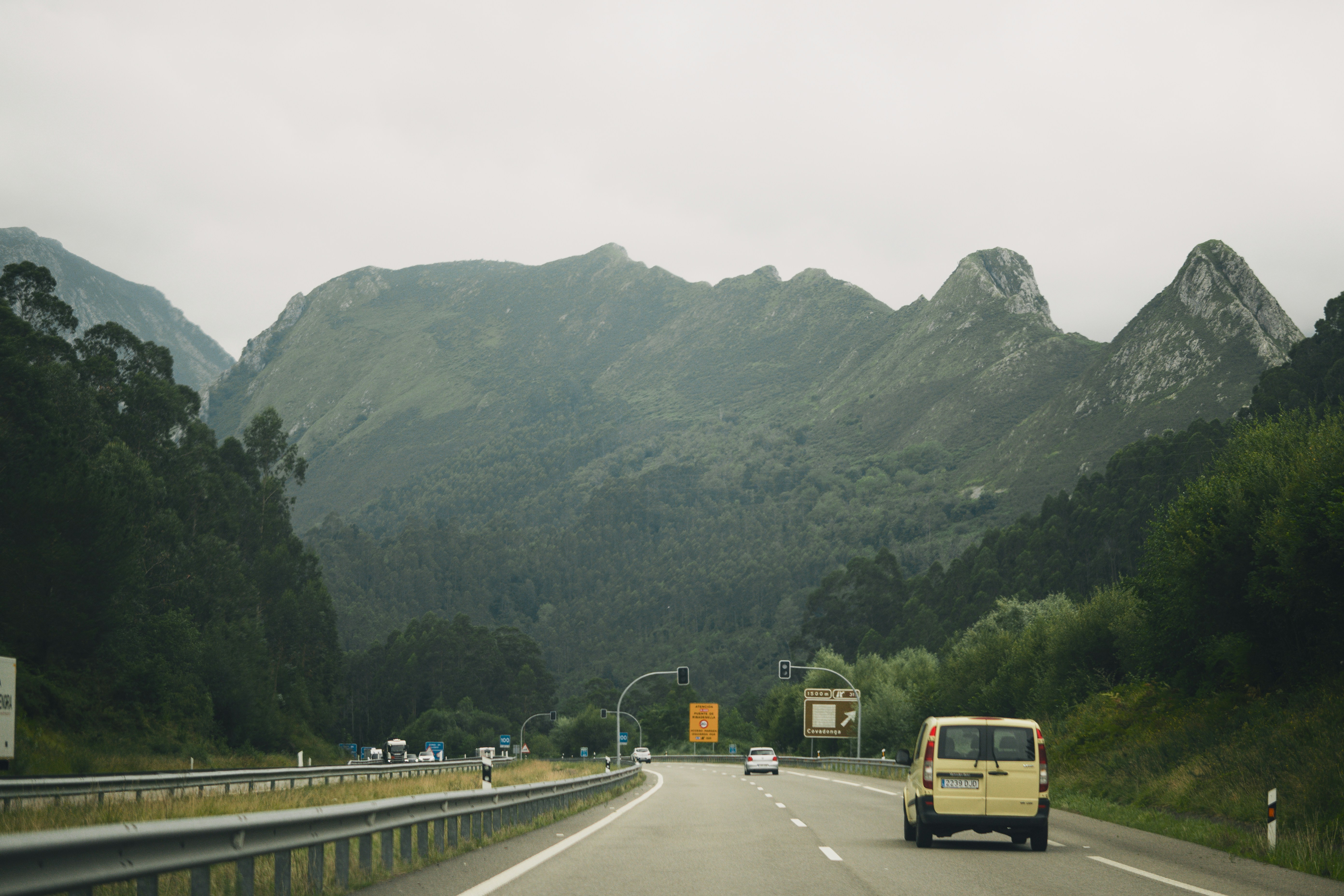 A van is driving down a mountain road