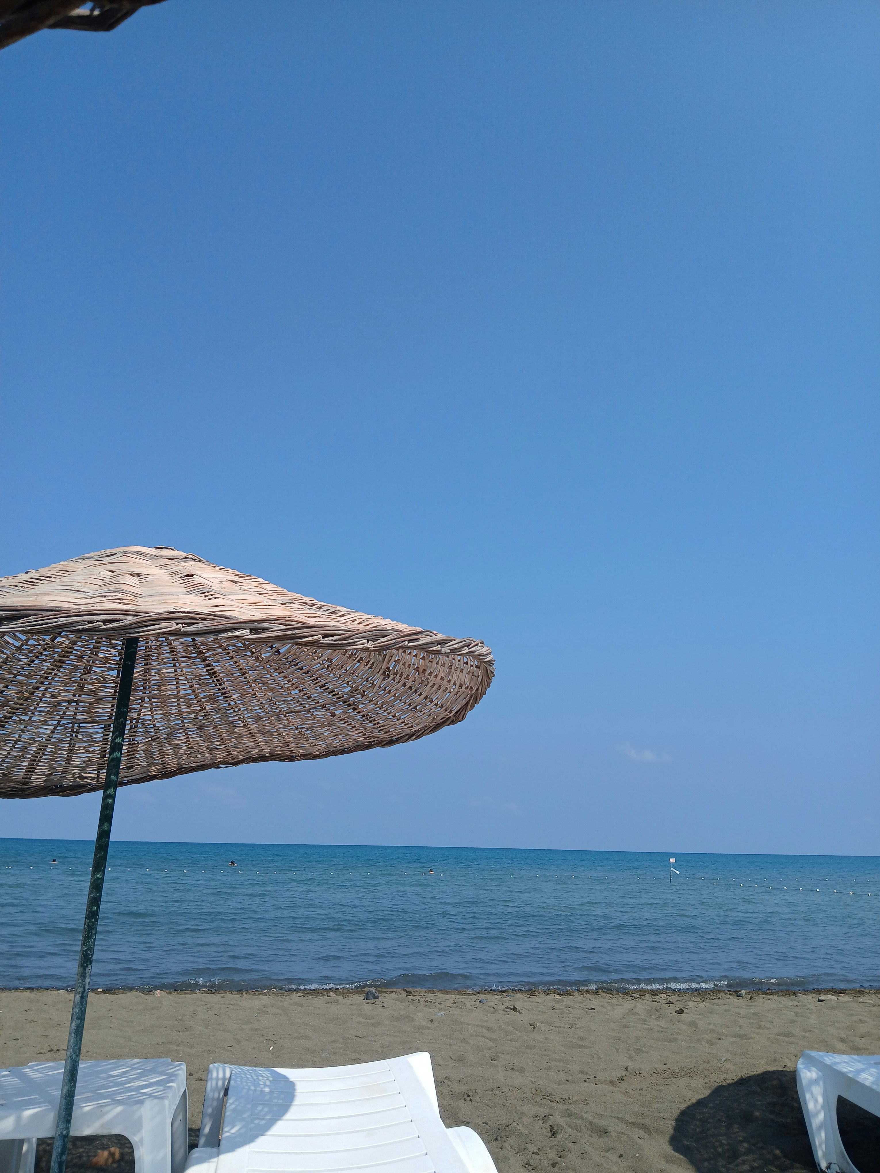 A couple of lawn chairs sitting on top of a beach