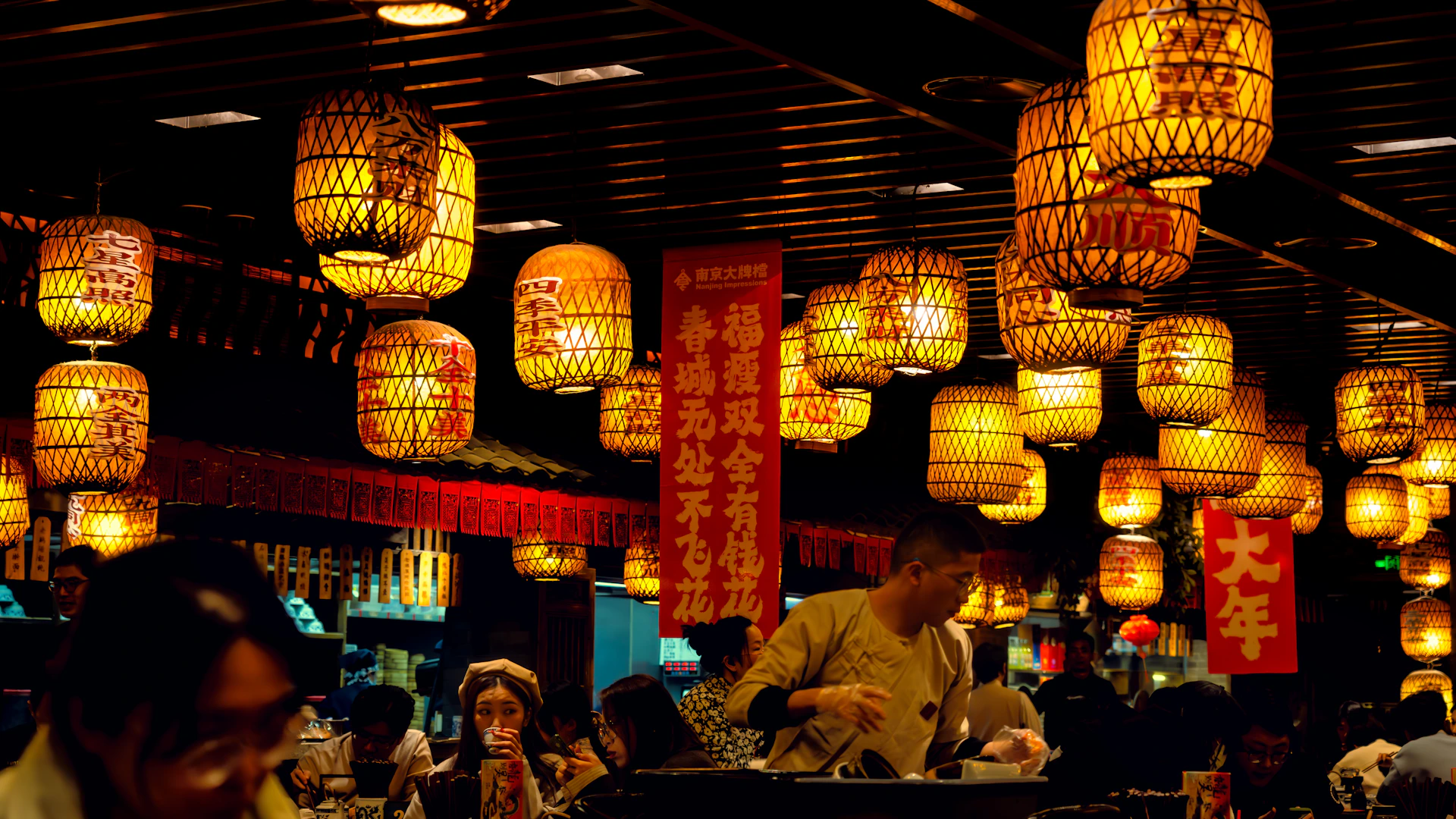 A group of people sitting at a table in a restaurant