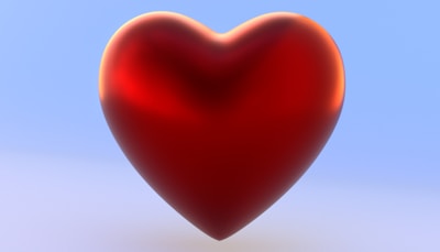 A red heart shaped object on a blue background