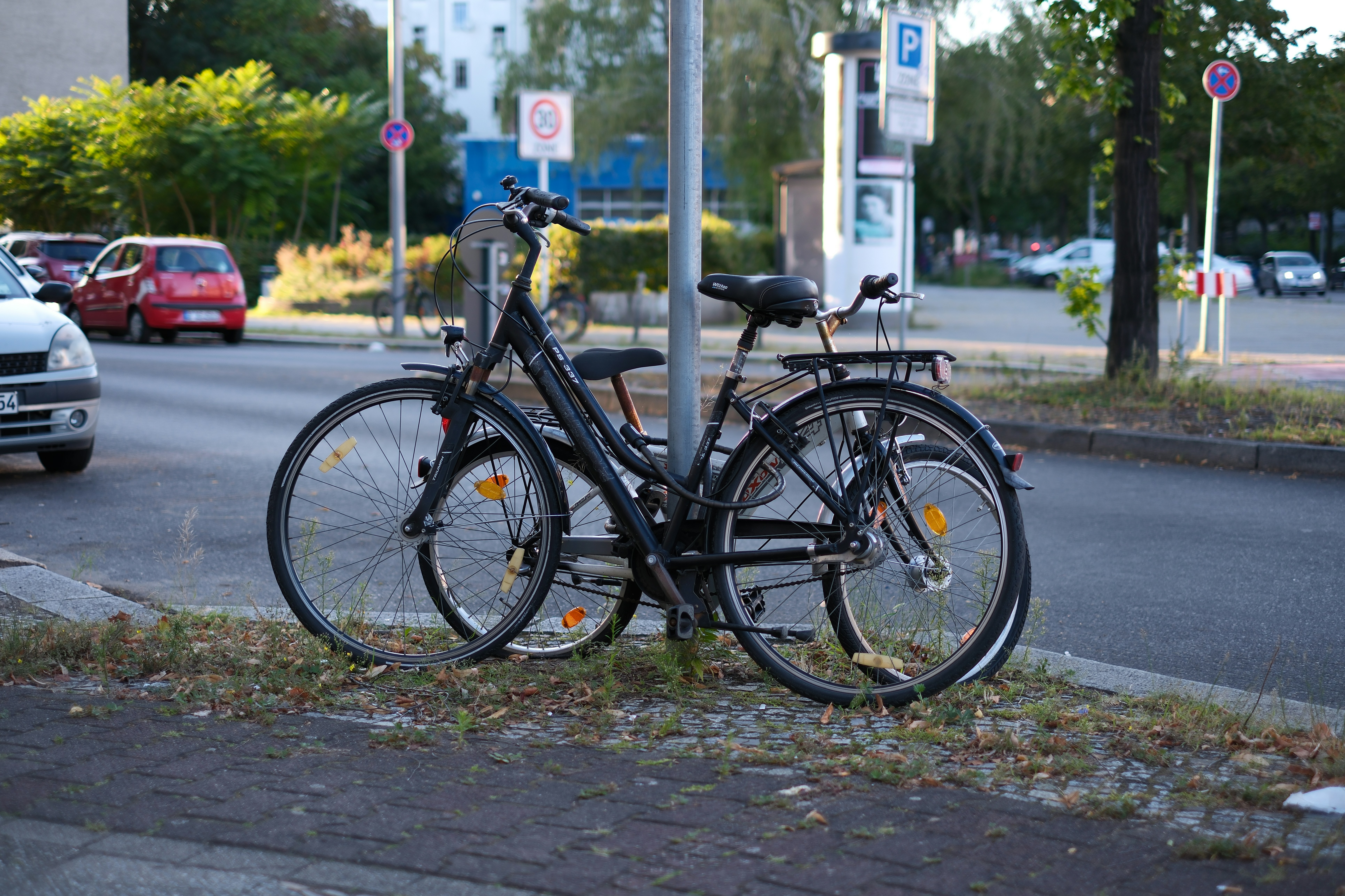 A couple of bikes parked on the side of a road - a-couple-of-bikes-parked-on-the-side-of-a-road--KgPKZ-GqtA