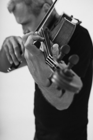 A man holding a violin in his hands