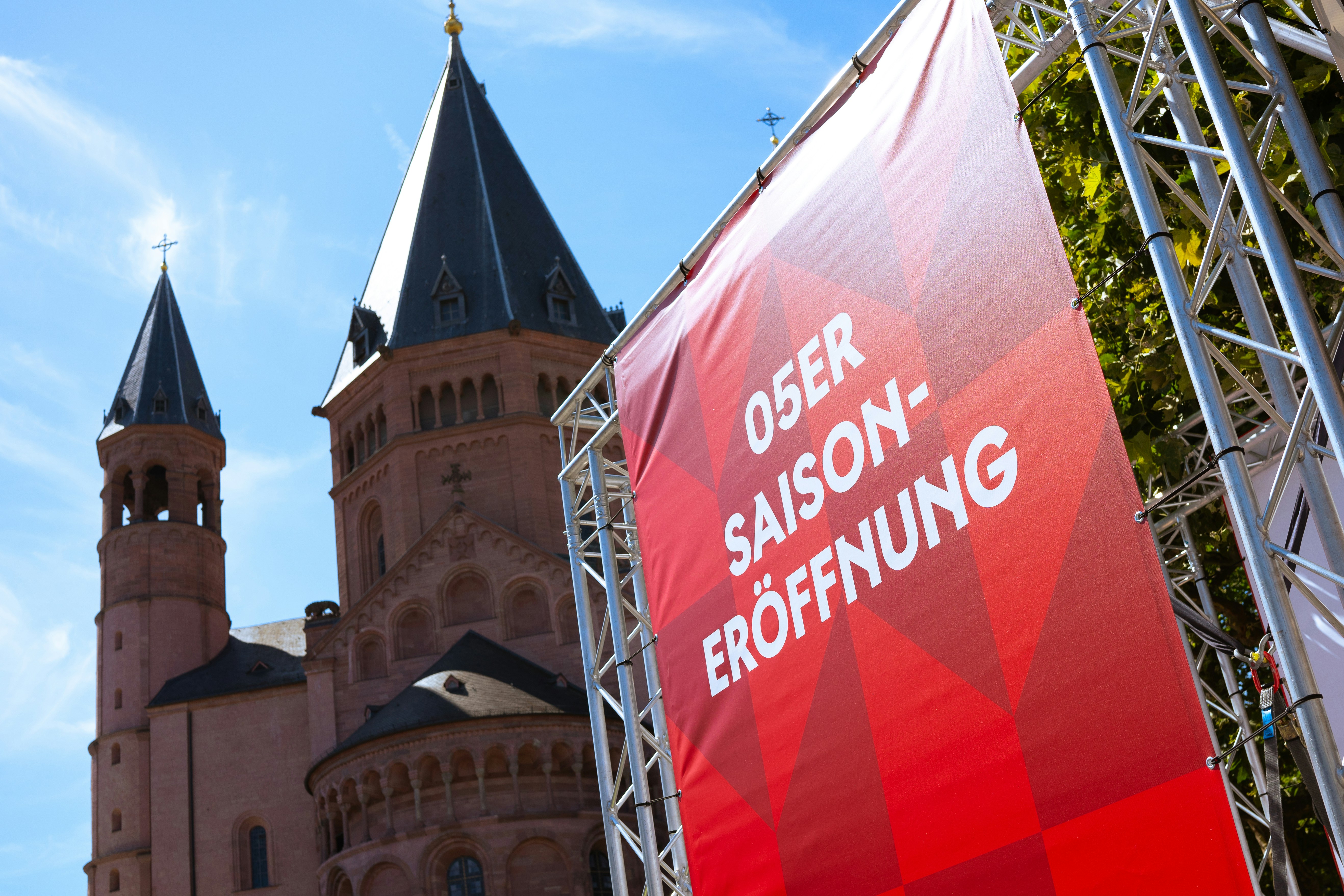 A red banner with a castle in the background
