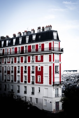 A red and white building with windows and balconies