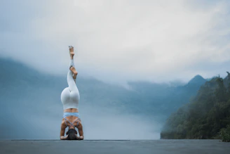 A person doing a handstand on a road