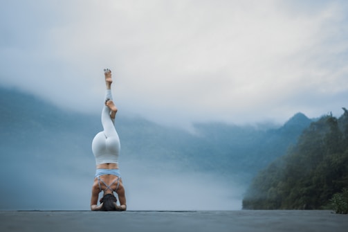 A person doing a handstand on a road