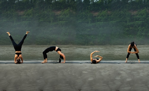 A group of people doing yoga on the beach