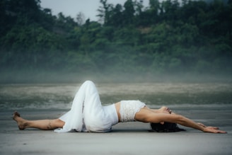 A woman laying on her back on the beach