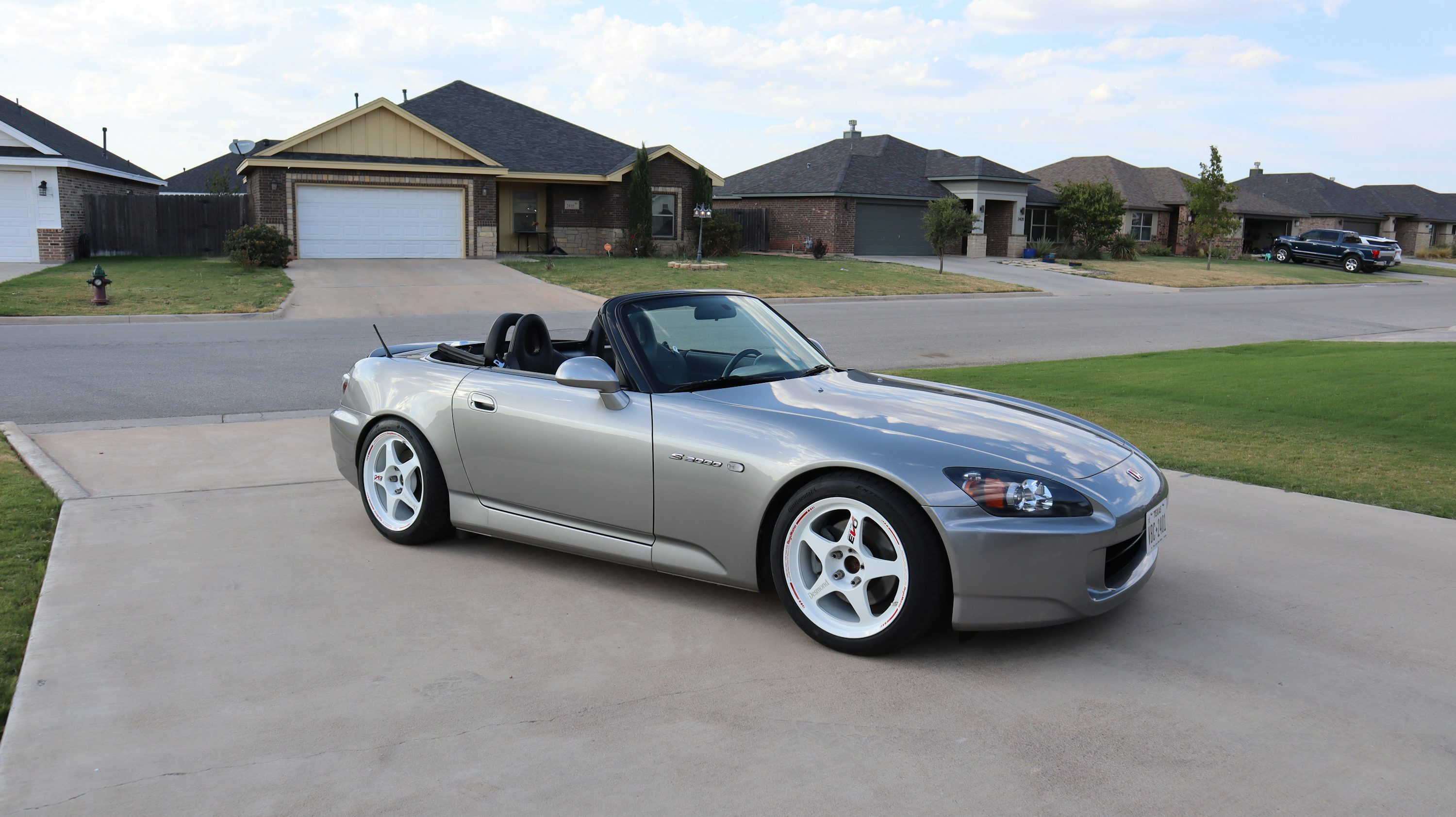 A silver sports car parked in a driveway
