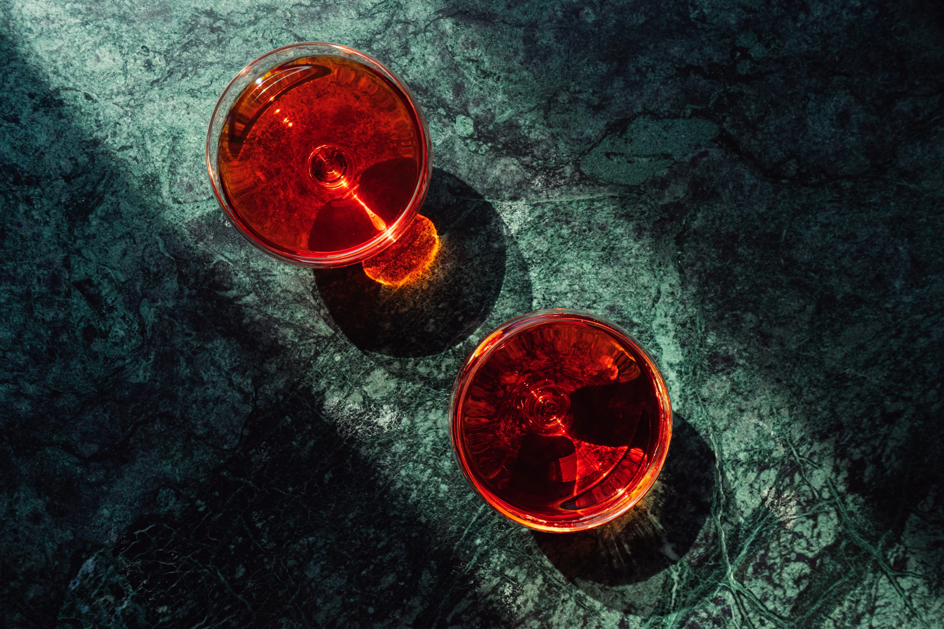 Two red cups sitting next to each other on a table