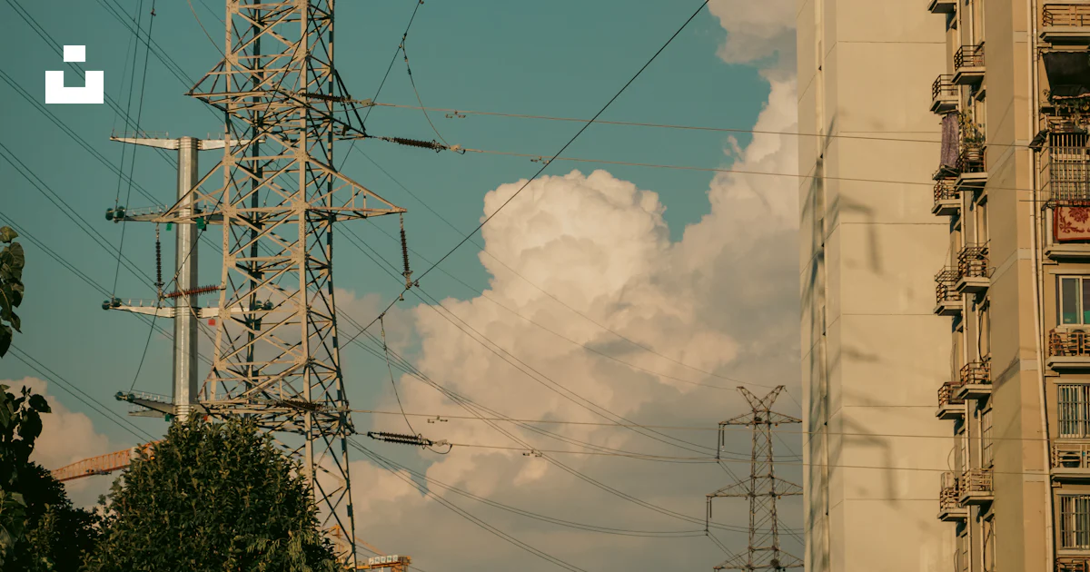 High Rise Building Power A high rise building with power lines in the foreground photo – Free ...