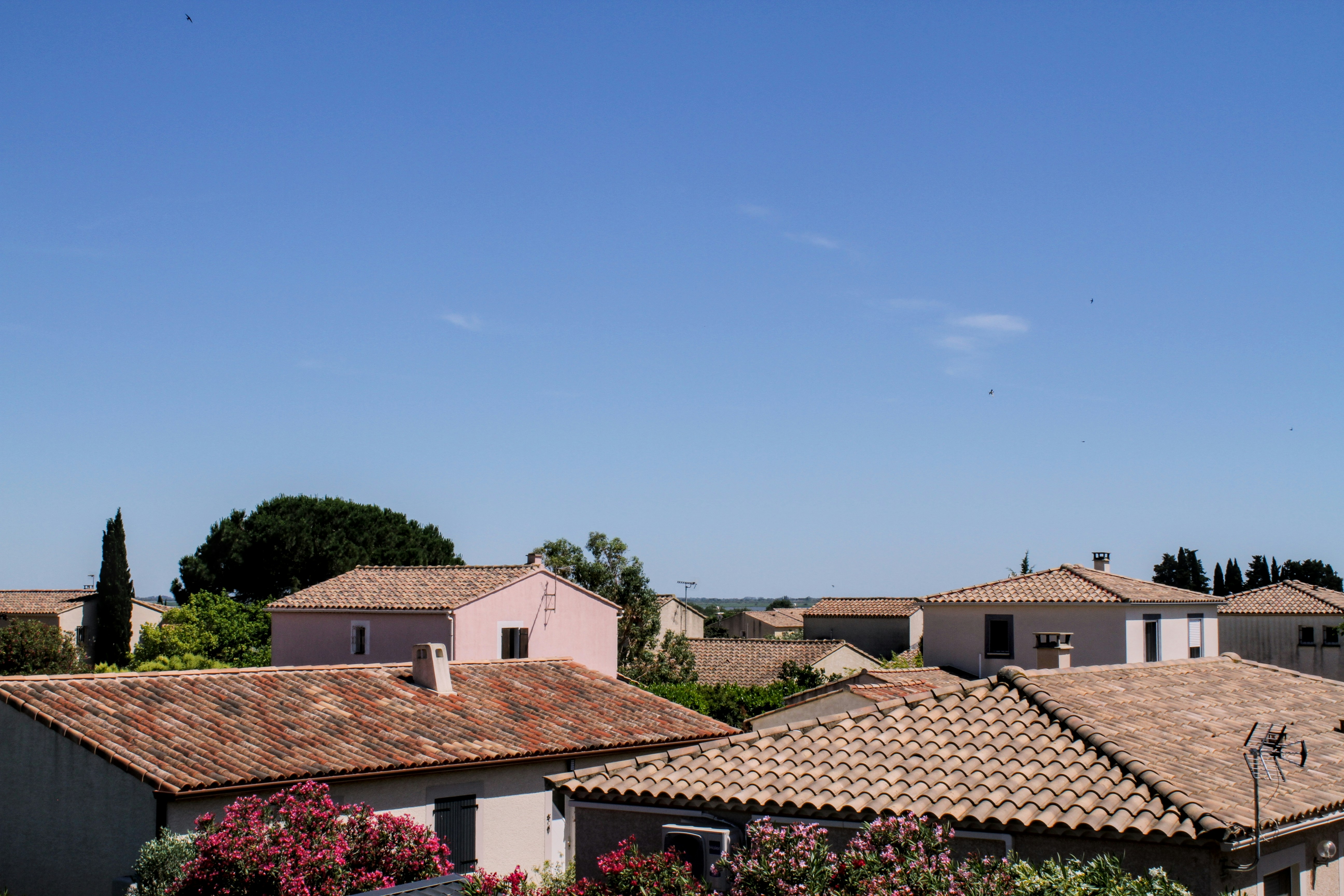 A view of a house with a clock tower in the background