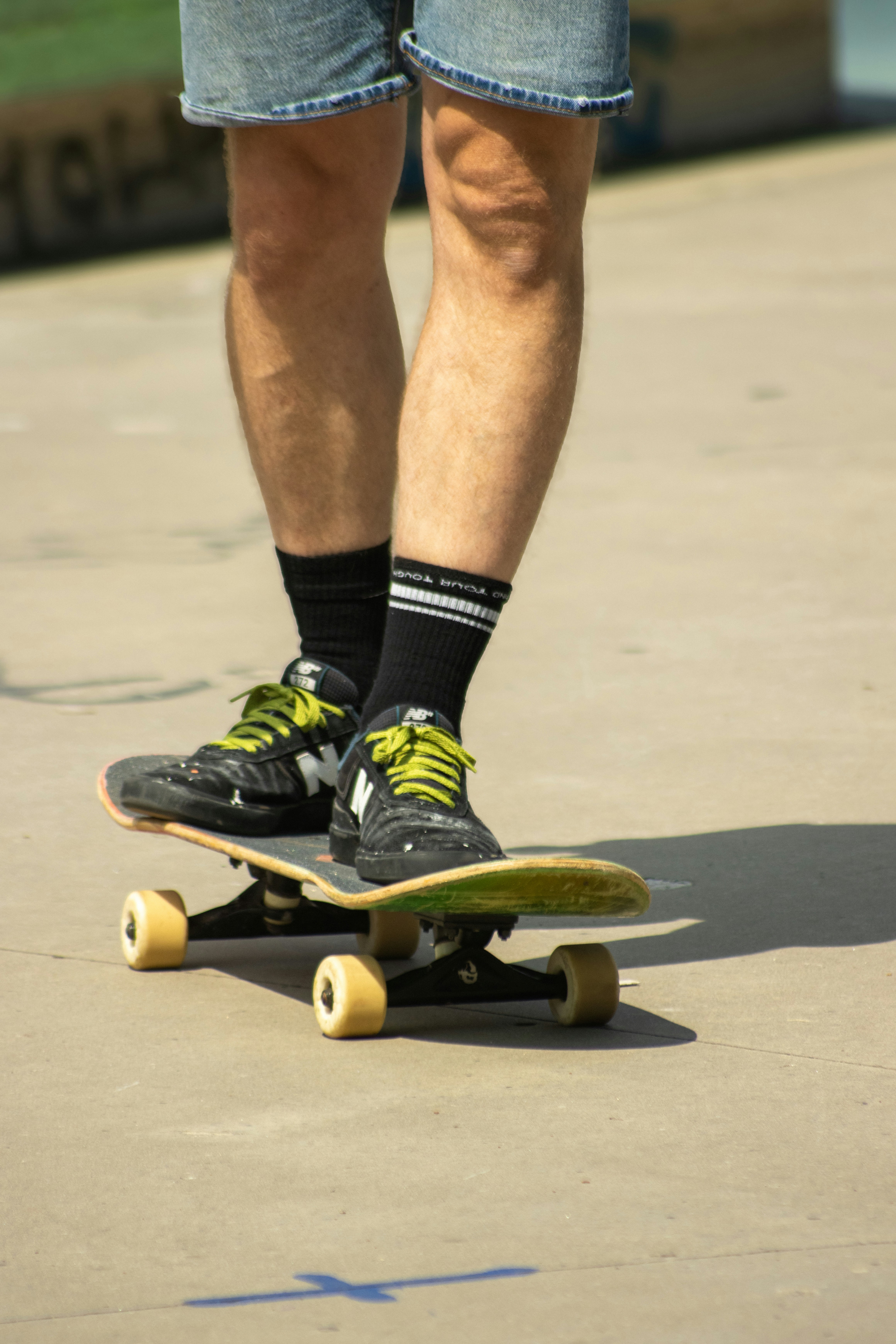 A skateboarder wearing black and yellow shoes