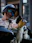 A man riding a motorcycle with a dog on the back of it