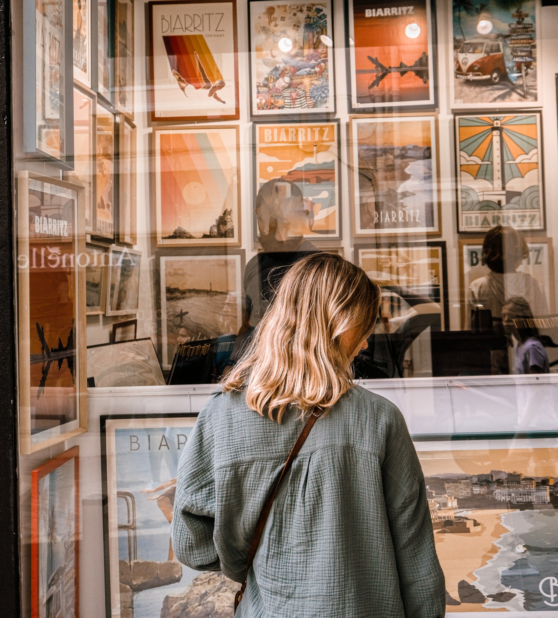 A woman standing in front of a store window