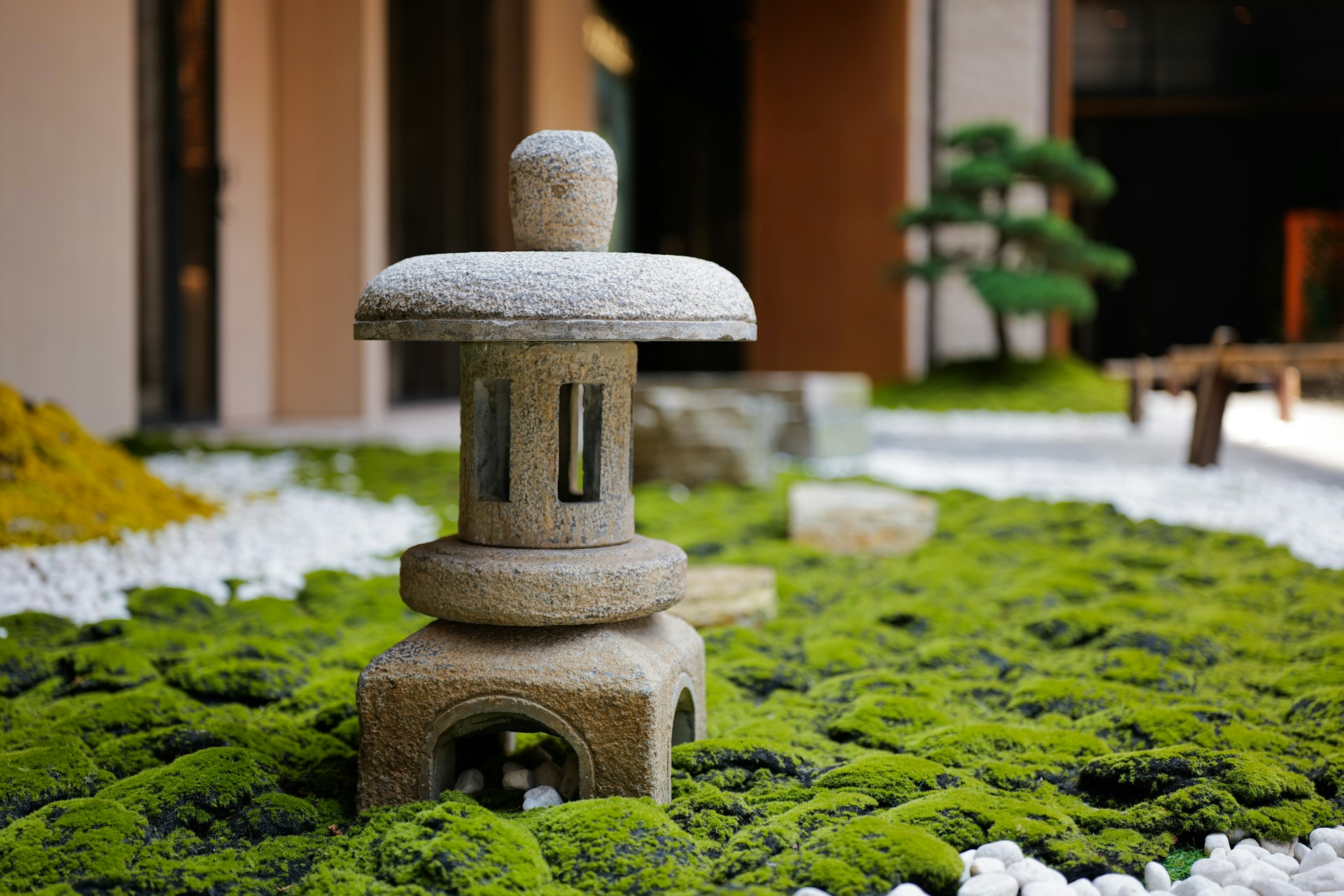 A stone lantern sitting on top of a lush green field