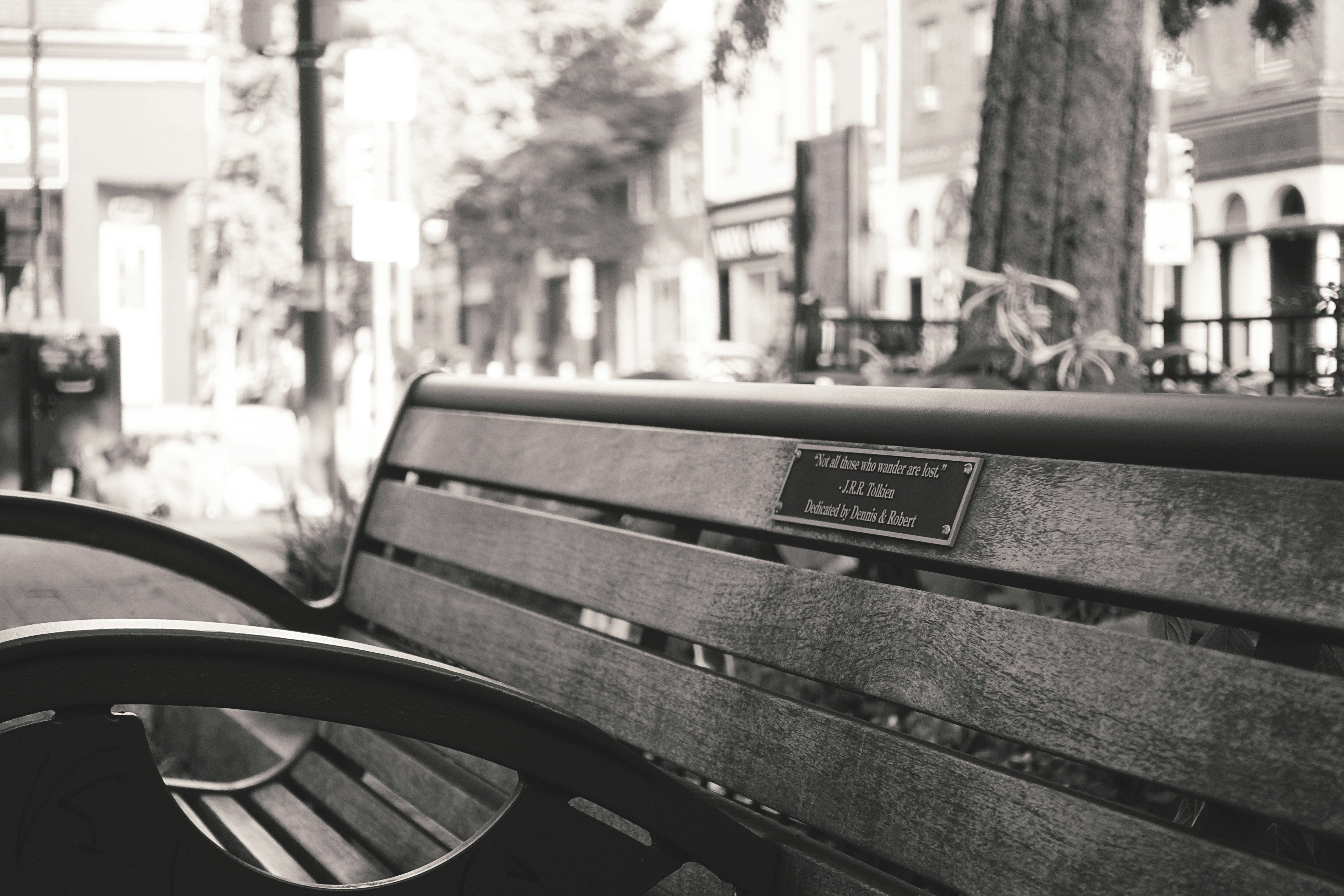 A black and white photo of a park bench