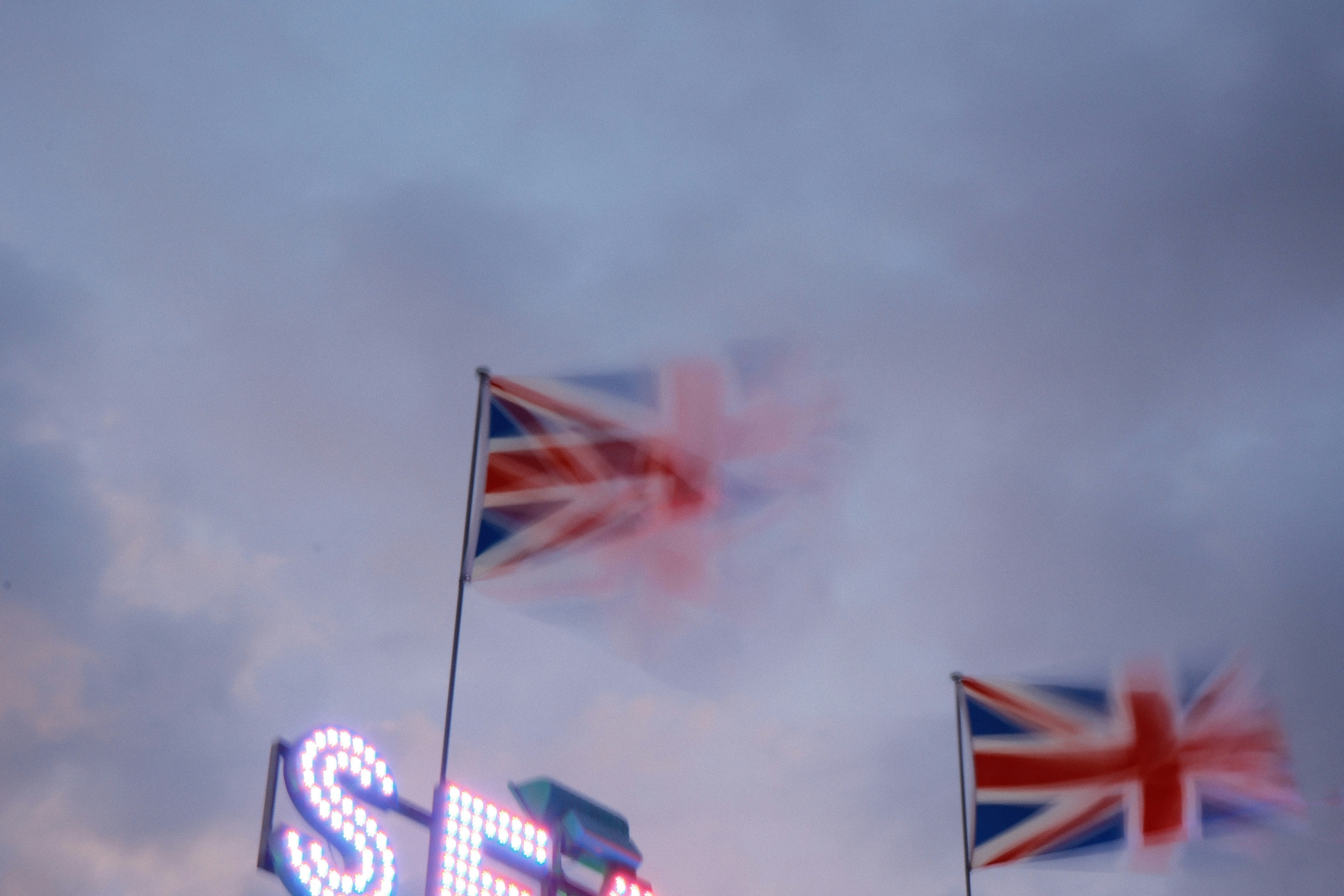 Flags flying in the wind on a cloudy day