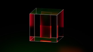 A red and green cube on a black background