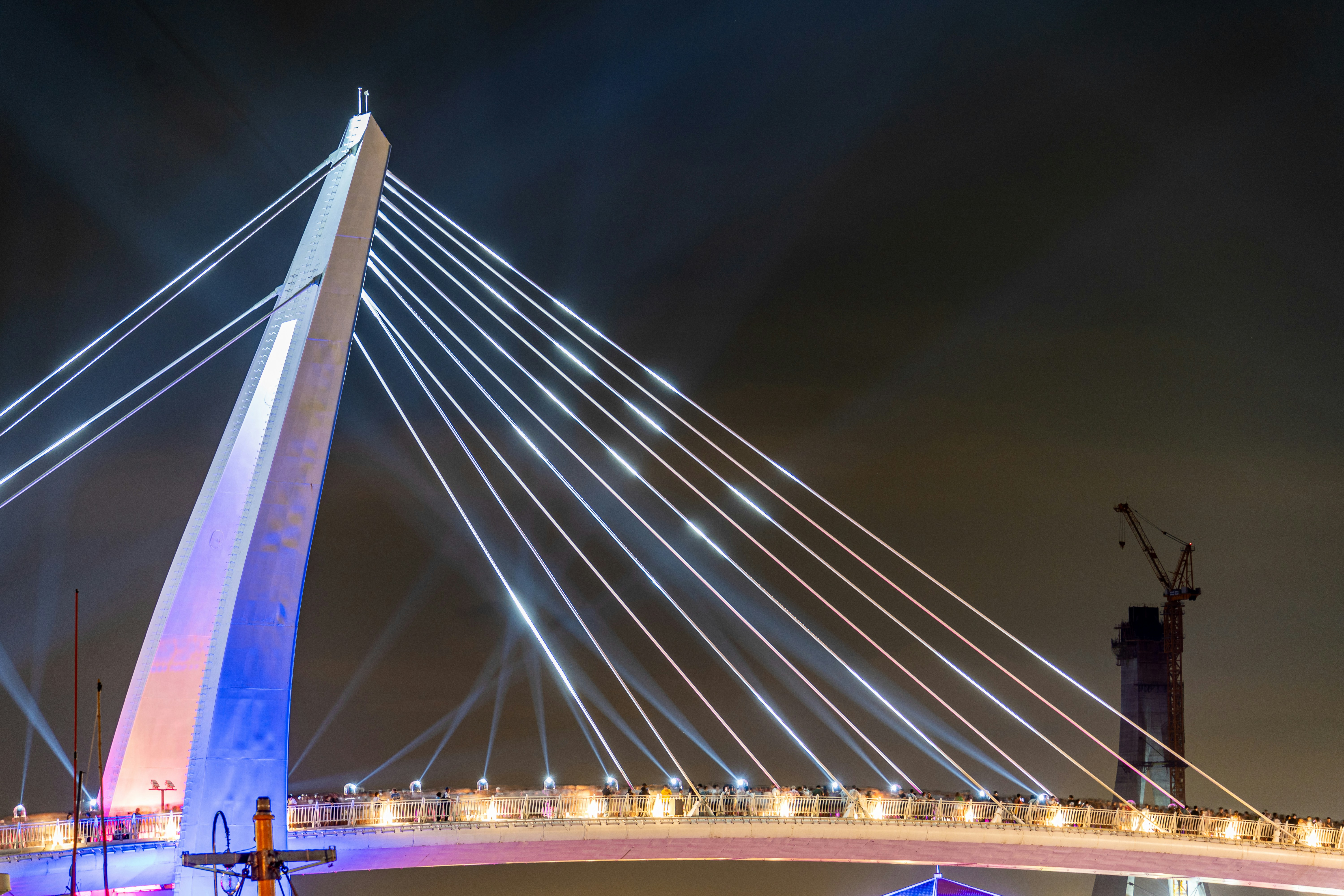 A bridge that is lit up at night
