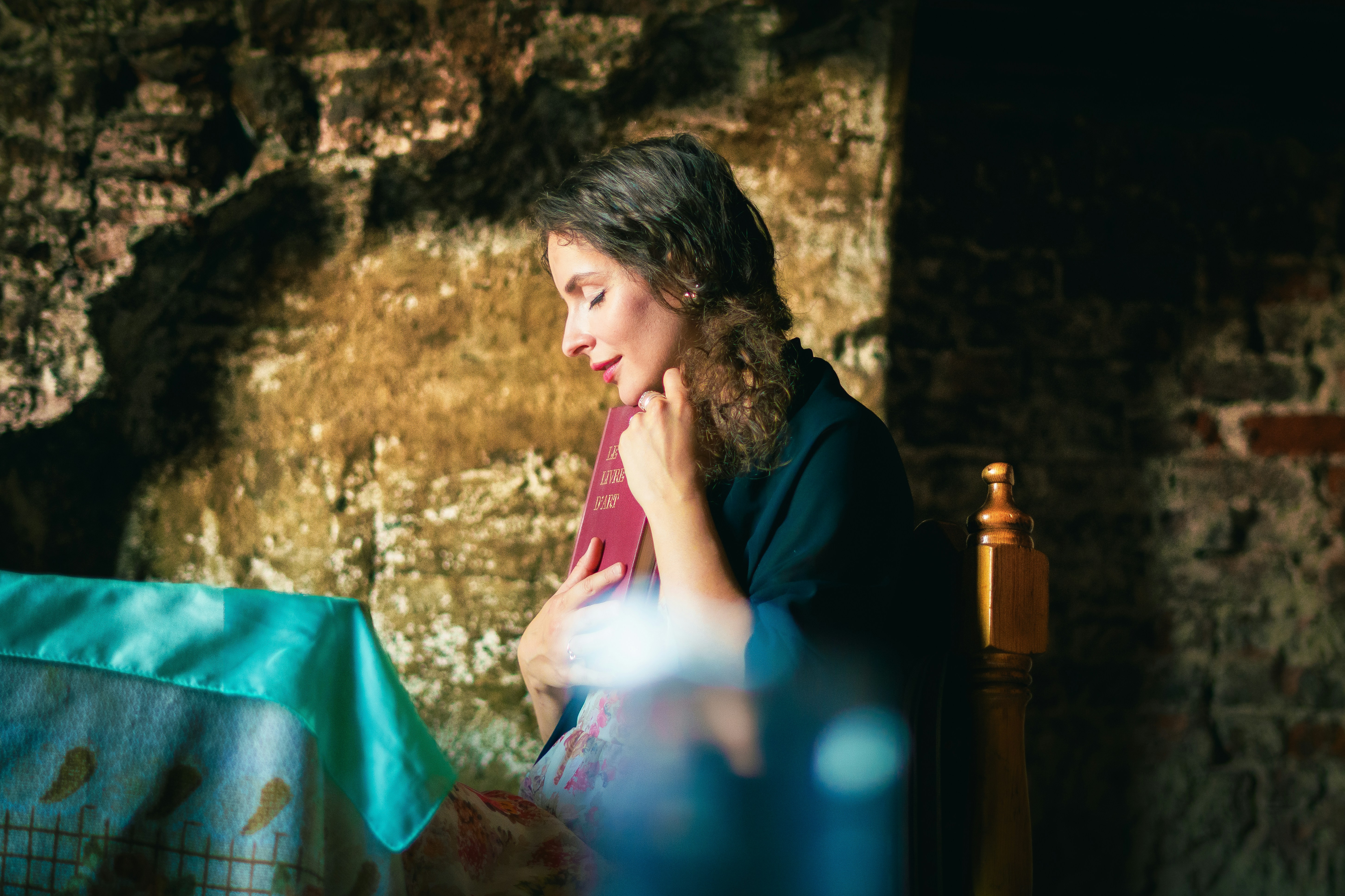 A woman sitting at a table looking at a laptop