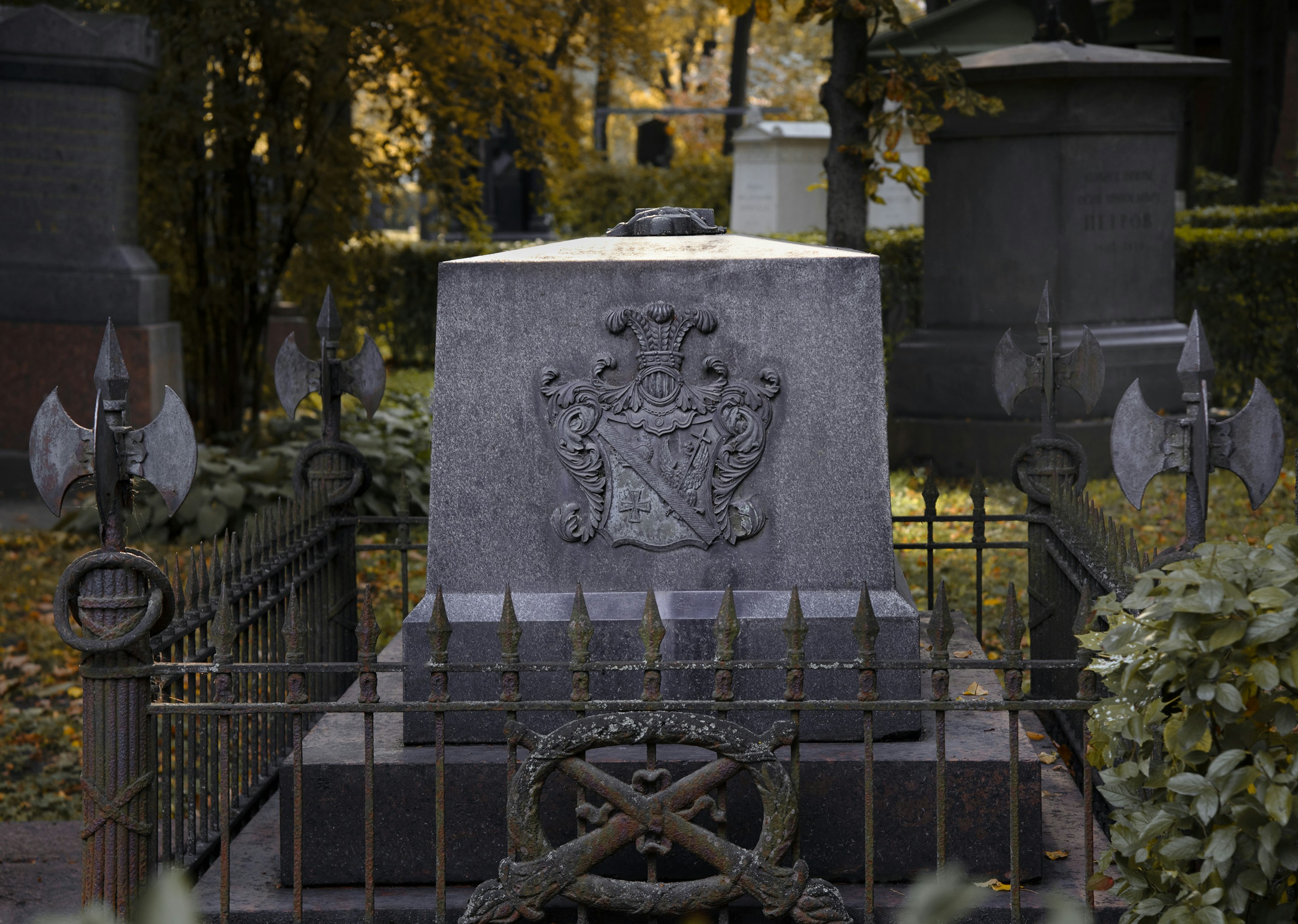 A grave in a cemetery surrounded by trees