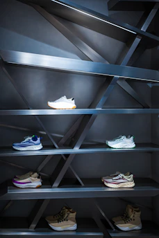 A display case with a bunch of shoes on it
