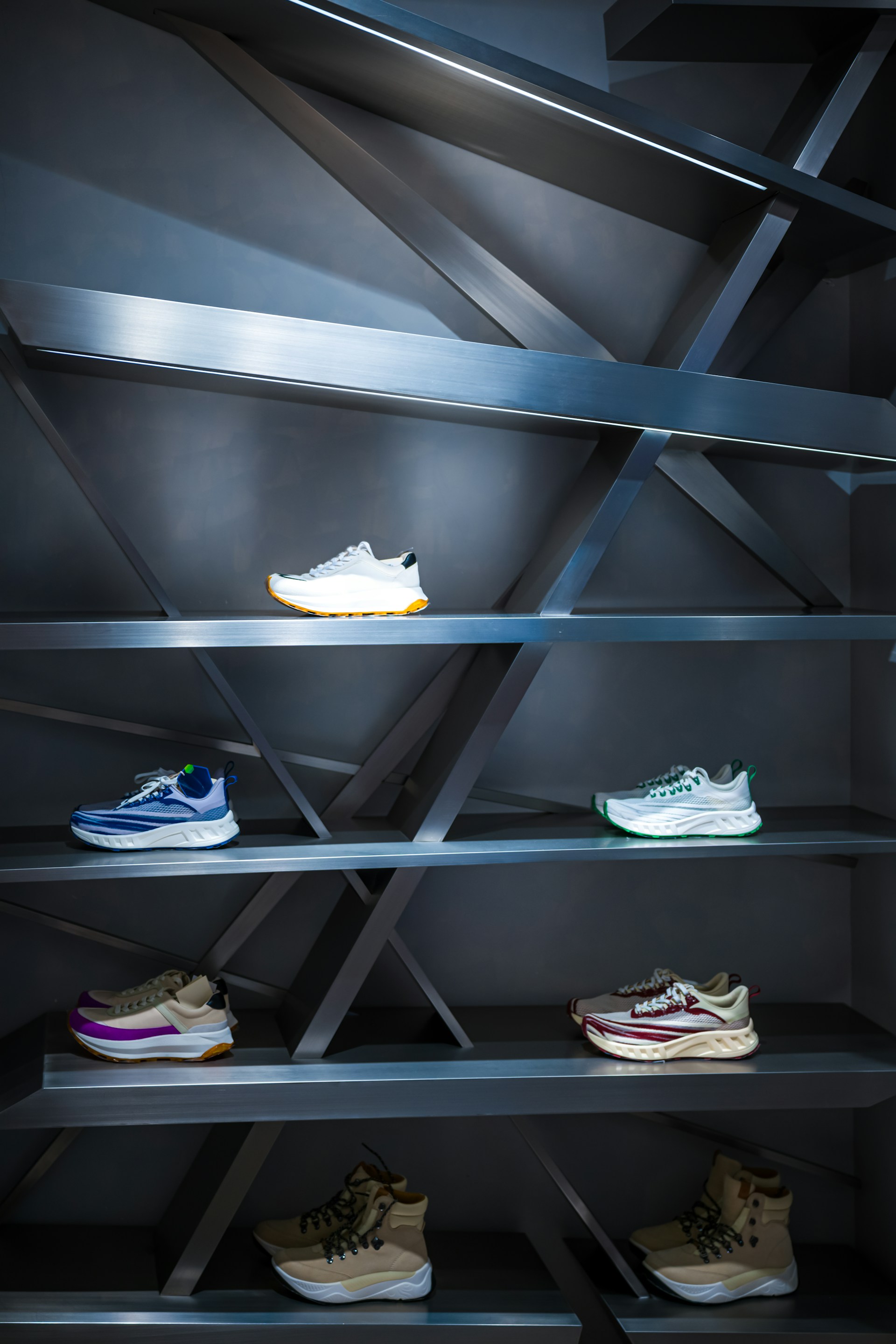 A display case with a bunch of shoes on it