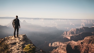 A man standing on the edge of a cliff