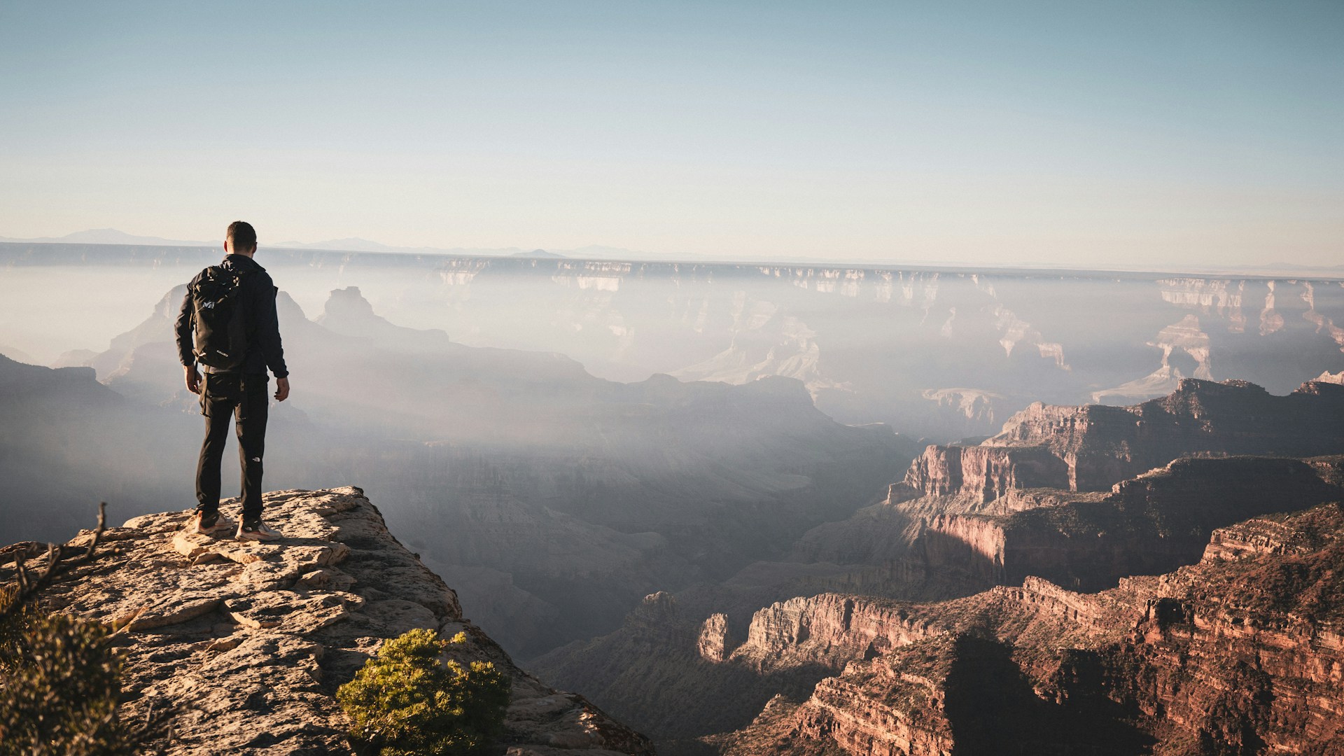 A man standing on the edge of a cliff