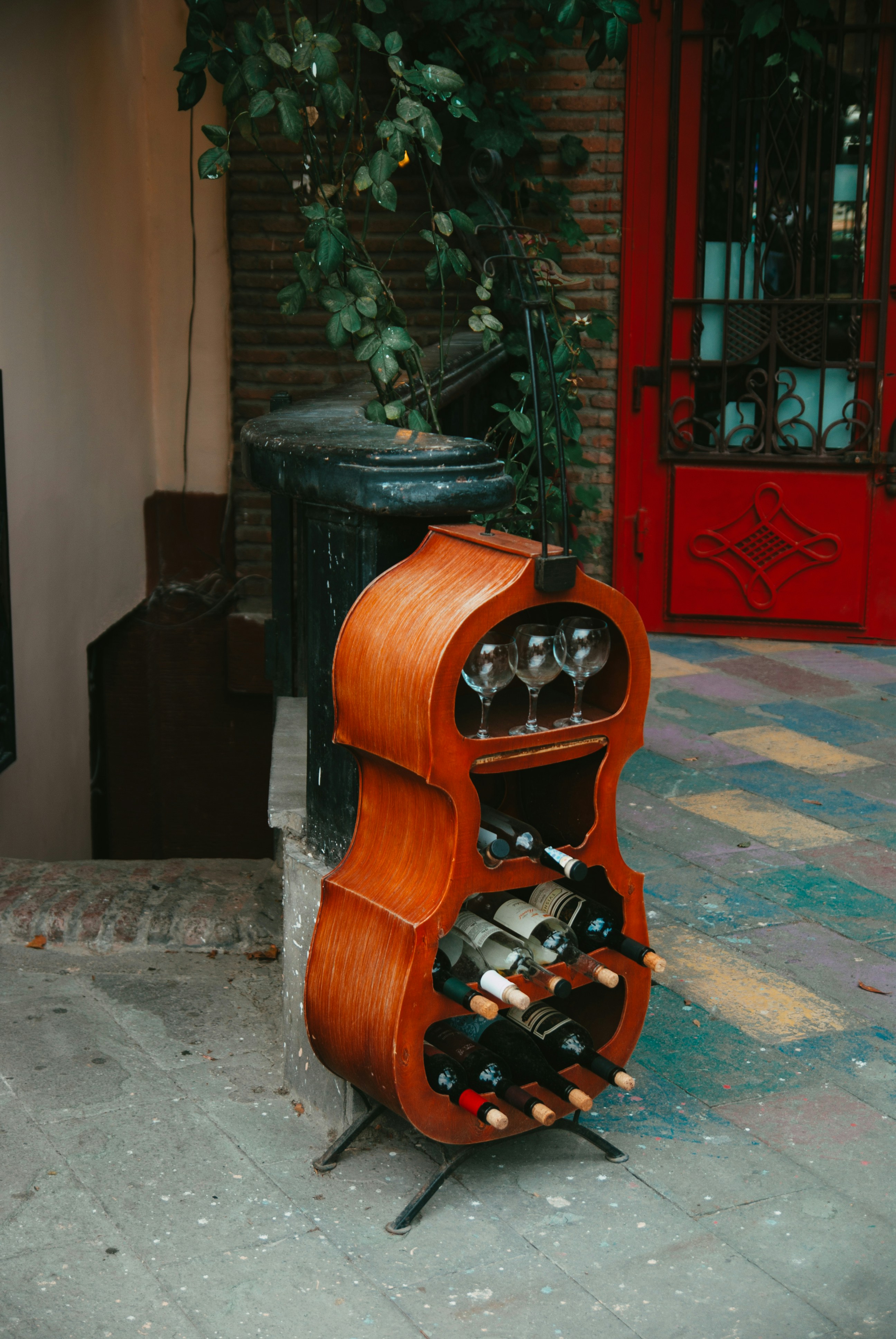 A wooden wine rack sitting on the side of a building