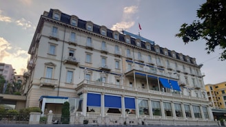 A large hotel building with blue shutters and windows