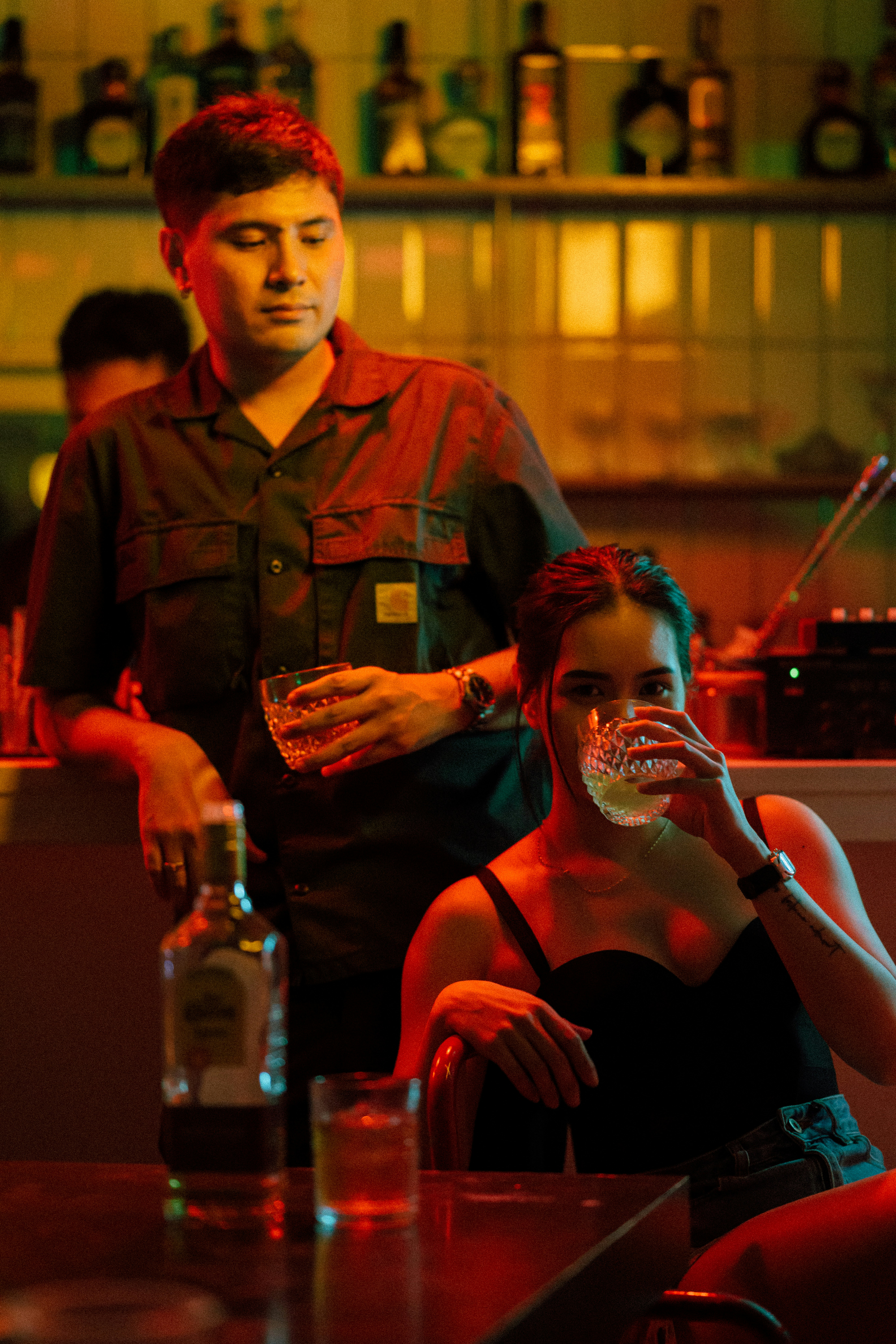 A man and a woman sitting at a bar