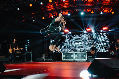 A person jumping in the air on a stage