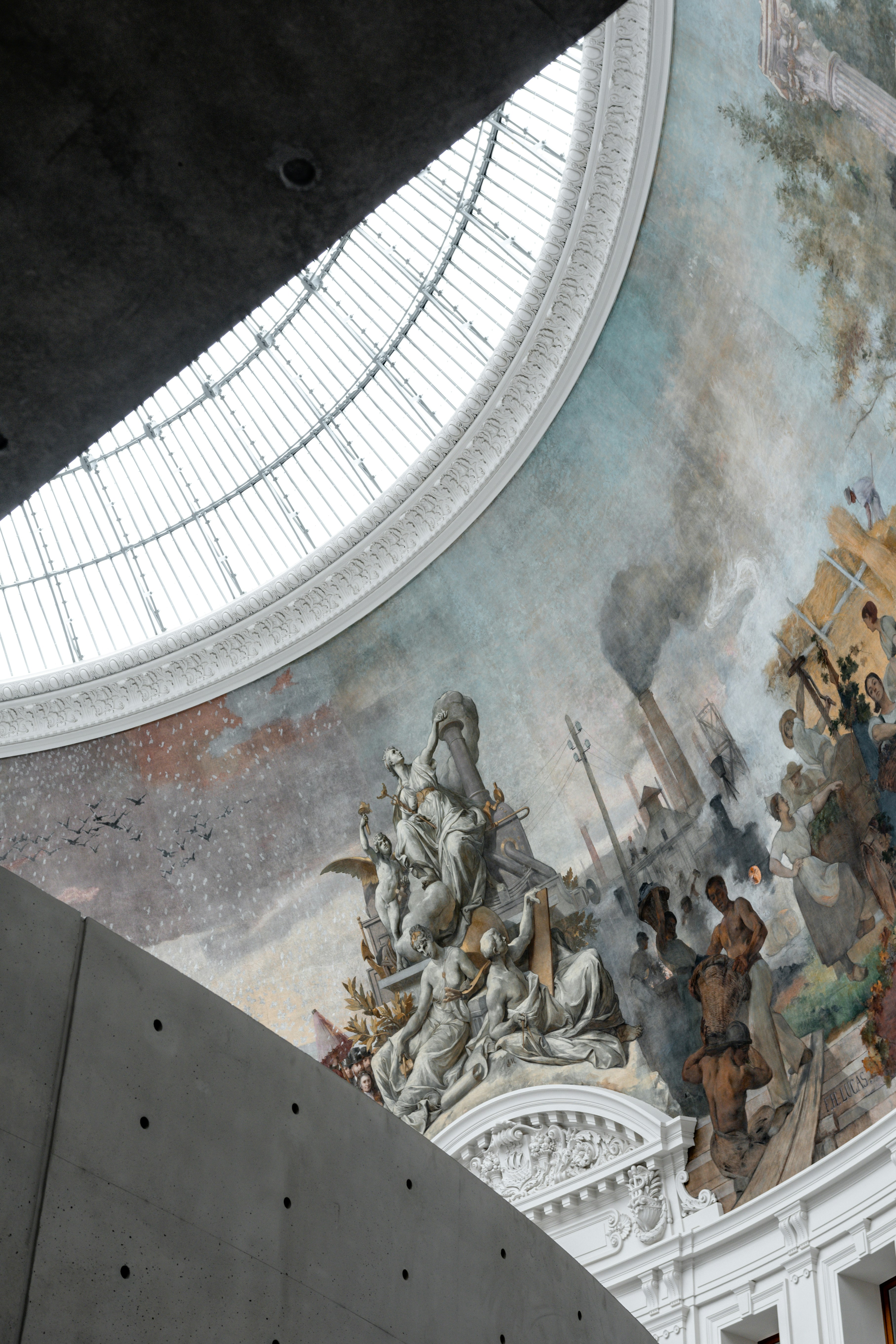 The ceiling of a building with a painting on it