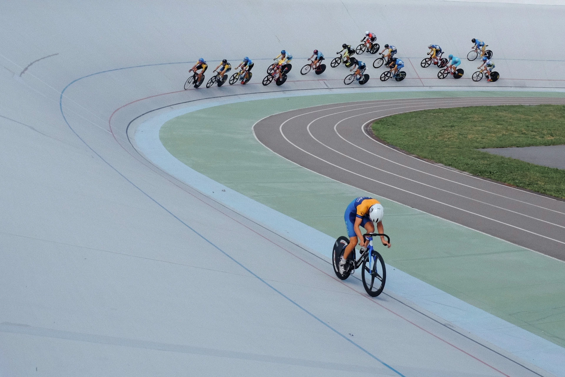 A group of people riding bikes on a track